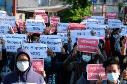 Protesters hold posters in support of the National Unity Government (NUG) during a demonstration against the military coup on "Global Myanmar Spring Revolution Day" in Taunggyi, Shan state on May 2, 2021.