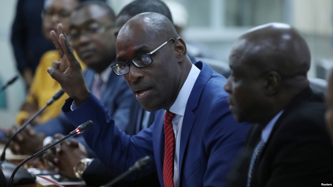 Haiti's Minister of Planning and External Cooperation Aviol Fleurant gestures as he speaks during a news conference about the resolution on the Oxfam scandal in Port-au-Prince, Haiti, June 13, 2018. 