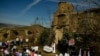 Devotees listen to mass accompanied by the three women known as ''La Mondidas'', during a religious pilgrimage in honor of Saint Bartholomew in the small village of Sarnago, northern Spain, Aug. 26, 2018.