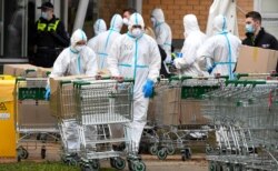 Members of the Melbourne Fire Brigade (MFB) prepare to take food parcels to residents in a locked down public housing estate in Melbourne, as the city re-enters a citywide lockdown after a fresh outbreak of COVID-19. July 9, 2020.