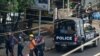 FILE - Police arrest people as part of a crackdown on demonstrations against the military coup, in Yangon, Myanmar, Feb. 27, 2021. Journalists are now being increasingly targeted for detentions. 