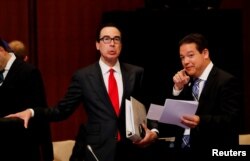 U.S. Treasury Secretary Steven Mnuchin talks with a delegate during the G20 finance ministers and central bank governors meeting in Fukuoka, Japan, June 8, 2019.