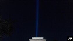 A beam of light is visible over the Lincoln Memorial, the day before the 20th anniversary of the Sept. 11 terrorist attacks, as part of the Towers of Light Tribute near the Pentagon, Friday Sept. 10, 2021, in Washington. (AP Photo/Jose Luis Magana)