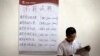 FILE - Chinese man reads the employment newsletters at a job fair held at the China International Exhibition Center in Beijing. 