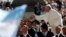 Pope Francis greets people as he arrives to lead his Wednesday general audience in Saint Peter's square at the Vatican, Sept. 18, 2013.