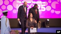 Denmark's Minister for Development Cooperation Rasmus Prehn, left, Crown Princess Mary of Denmark, center, and Kenya's President Uhuru Kenyatta, right, attend the International Conference on Population and Development summit in Nairobi, Nov. 12, 2019.