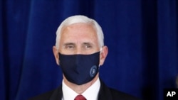 Vice President Pence wears a mask as he is introduced to speak to the Commissioned Corps of the U.S. Public Health Service at their headquarters in Rockville, Md., June 30, 2020. 