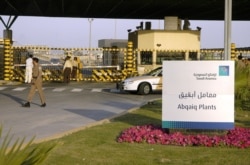 FILE - Saudi security guards the entrance of the oil processing plant of the Saudi state oil giant Aramco in Abqaiq in the oil-rich Eastern Province, Feb. 25, 2006.