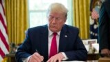 (FILE) President Donald Trump signs an executive order to increase sanctions on Iran, in the Oval Office of the White House, Monday, June 24, 2019, in Washington. 
