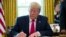 (FILE) President Donald Trump signs an executive order to increase sanctions on Iran, in the Oval Office of the White House, Monday, June 24, 2019, in Washington. 