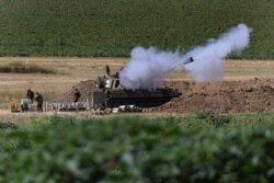 An Israeli artillery unit fires toward targets in Gaza Strip, at the Israeli Gaza border, May 18, 2021.