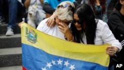 Opposition supporters hold a Venezuelan flag during a prayer event with opposition leader Maria Corina Machado and presidential candidate Edmundo Gonzalez in Caracas, Venezuela, July 21, 2024. Venezuela is set to hold presidential elections July 28. 