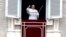 Pope Francis waves to the crowd as he arrives for the Angelus noon prayer from the window of his studio overlooking St.Peter's Square, at the Vatican, Feb. 25, 2018. 