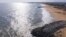 This aerial view shows a groyne (shore protection structure), on a beach east of Cotonou on October 23, 2023.