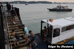 Visitors leave a ferry to enter Singapore’s Pulau Ubin island, November 1, 2024. (REUTERS/Edgar Su)