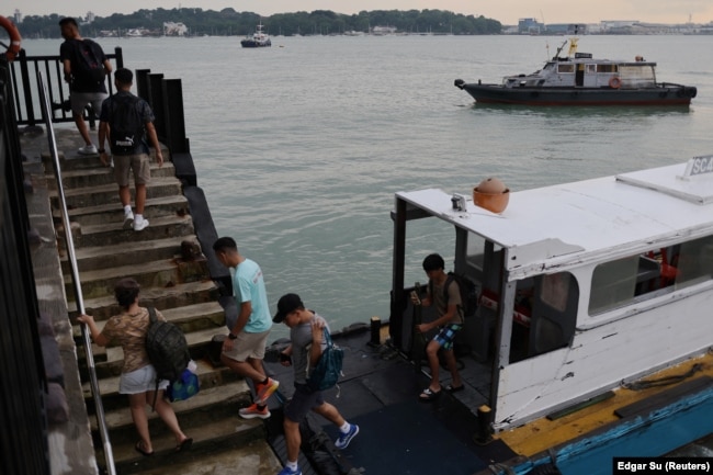 Visitors leave a ferry to enter Singapore’s Pulau Ubin island, November 1, 2024. (REUTERS/Edgar Su)