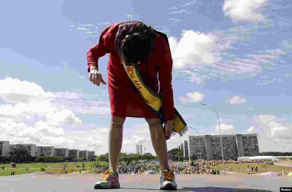 A demonstrator dressed as Brazil&#39;s President Dilma Rousseff takes part in a protest in Brasilia, April 12, 2015.