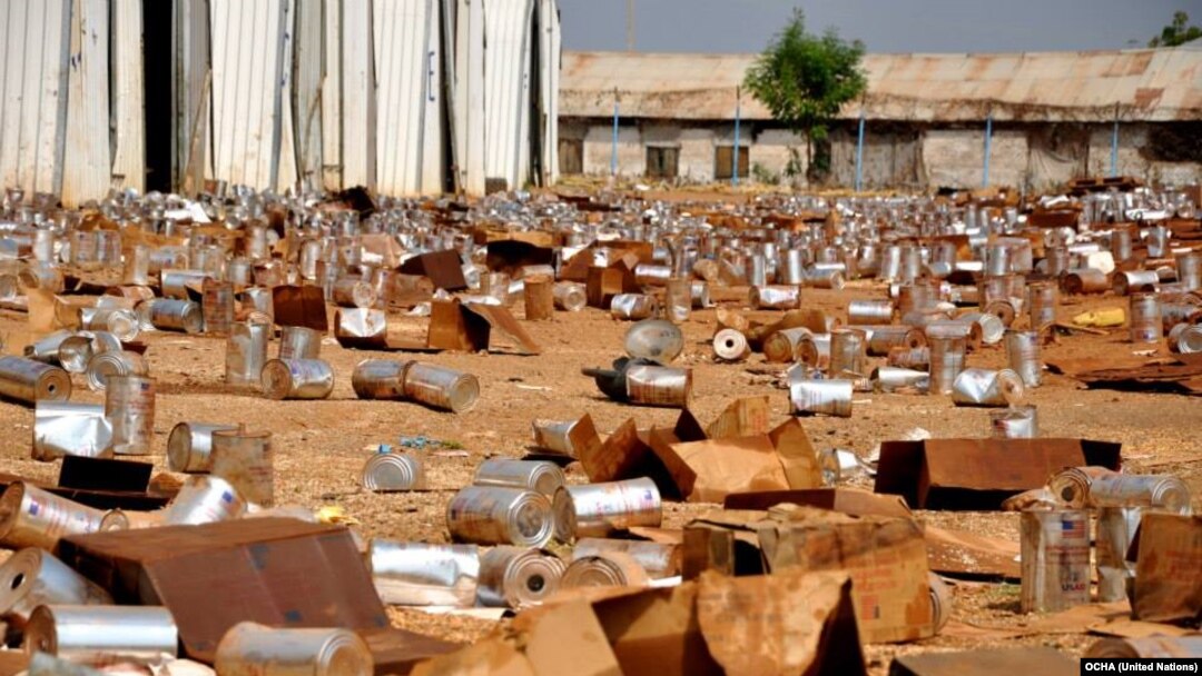 FILE - Empty tins litter the ground at the looted compound of an aid agency in Malakal, South Sudan.