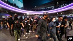 Pro-democracy protesters march to a local police station demanding the release of pro-democracy activists in Bangkok, Thailand, Feb. 10, 2021. 