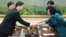 In this photo released by the South Korean Unification Ministry, South Korea's Unification Policy Officer Chun Hae-sung, left, shakes hands with the head of North Korea's delegation Kim Song Hye, right, after ending their meeting at the southern side of P