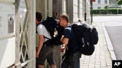 FILE - Backpackers enter a hostel in Brussels, Belgium, July 31, 2008.