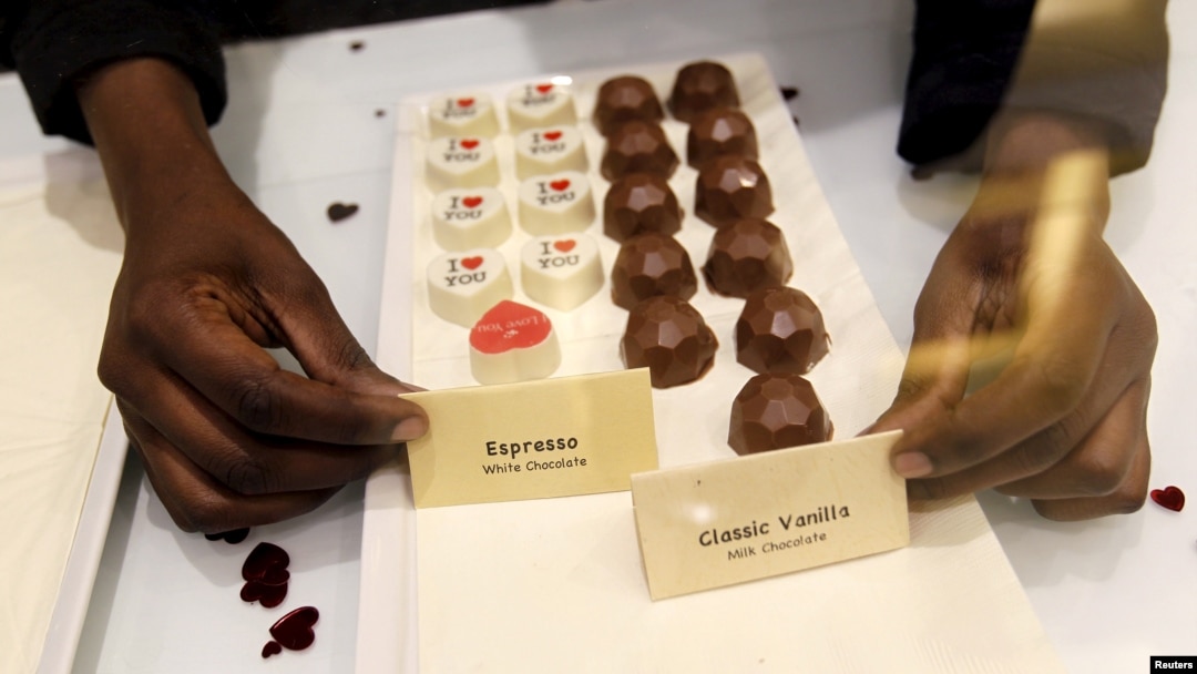 A sales worker arranges chocolate products inside the Absolute Chocolate shop in Kenya's capital, Nairobi, March 20, 2015. 