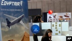 Employees work at the EgyptAir counter which reopened at Charles de Gaulle Airport outside of Paris, Thursday, May 19, 2016. An EgyptAir flight from Paris to Cairo with 66 passengers and crew on board crashed in the Mediterranean Sea early Thursday morning off the Greek island of Crete, Egyptian and Greek officials said. (AP Photo/Michel Euler)