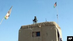 An Afghan soldier guards at a checkpoint in the Nad Ali district of Helmand province, Afghanistan, Dec. 22, 2015. Taliban advances in a restive province have prompted Britain to send a group of military advisers to help local forces in countering the insurgents.