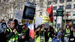 Yellow vest protesters march during a protest in Paris, Feb. 17, 2019. 