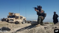 A member of Afghanistan's special forces points his gun as he observes the enemy lines in Achin district of Nangarhar province, in eastern Afghanistan April 14, 2017.