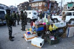 FILE - Soldiers secure an area after a grenade blast that killed at least one person and injured 17 at a market in Srinagar, Nov. 4, 2019.