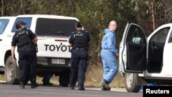 FILE - Police work near the scene of a fatal shooting, where police shot multiple people at a remote Queensland property after an ambush in which two officers and a bystander were also killed, in Wieambilla, Australia, Dec. 13, 2022. 