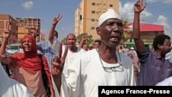 Supporters of the Umma Party, Sudan's largest political party, chant slogans during a protest against a military coup that overthrew the transition to civilian rule, on Oct. 29, 2021 in the capital Khartoum's twin city of Omdurman.