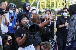 A demonstrator addresses the crowd gathered in front of a fence surrounding Lafayette Park outside the White House in Washington as protests continue over the death in police custody of George Floyd, June 2, 2020.