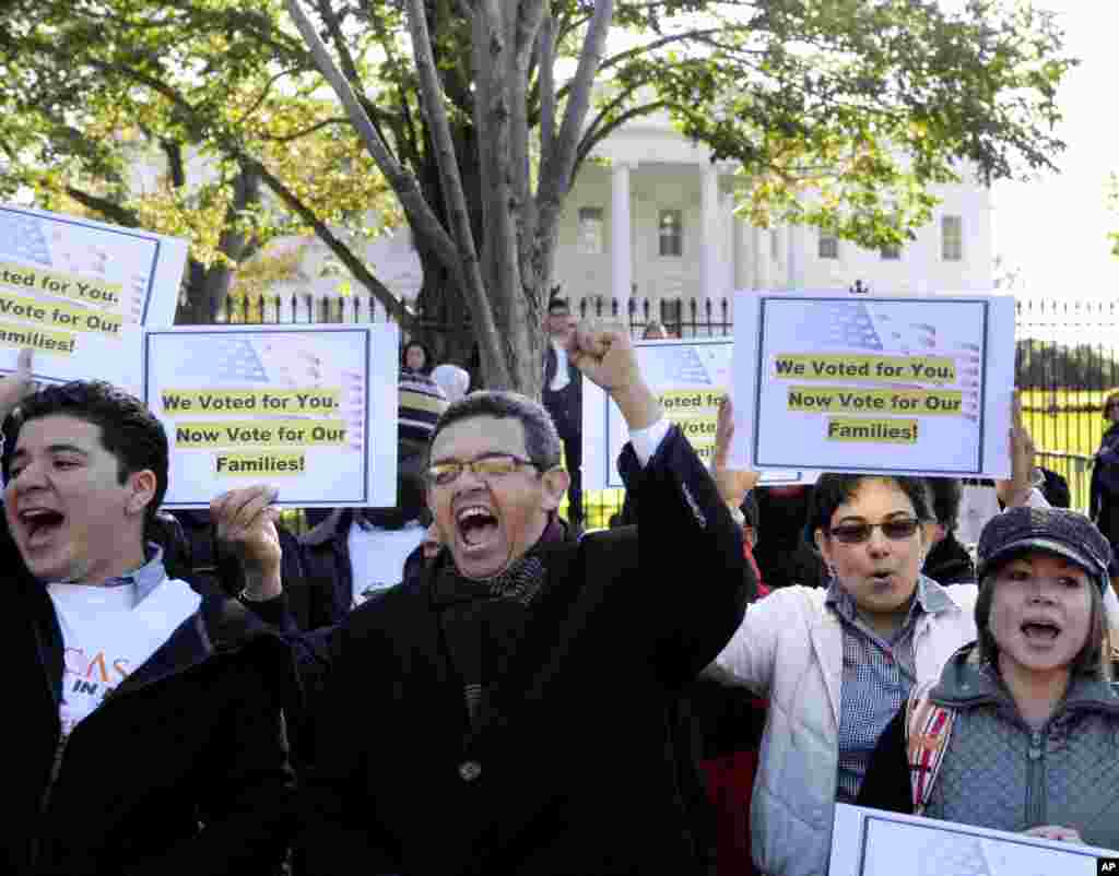 Gustavo Torres, director, Casa in Action, center, and others, chant during a rally of immigration rights organizations, including Casa in Action and Maryland Dream Act, in front of the White House in Washington, Thursday, Nov. 8, 2012, calling on President Barack Obama to fulfill his promise of passing comprehensive immigration reform. (AP Photo/Cliff Owen)