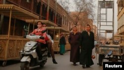 FILE - People was a long a shopping street in the old town of Kashgar, Xinjiang Uighur Autonomous Region, China, March 23, 2017. 