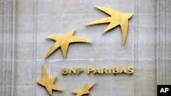 FILE - This Feb. 14, 2013, photo shows BNP Paribas' logo at its headquarters in Paris. 