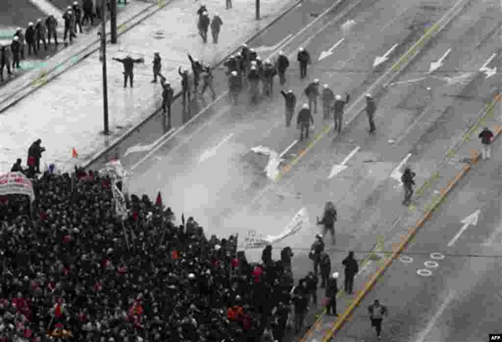 Riot police clash with protesters outside the Greek Parliament in central Athens during a demonstration, Wednesday, Dec. 15, 2010. Hundreds of protesters clashed with riot police across central Athens Wednesday, smashing cars and hurling gasoline bombs du