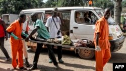 A wounded man is being carried into the General Hospital in Bangui on Sept. 26, 2015, after unknown assailants opened fire in the PK5 district, a neighborhood with a majority of Muslim residents.