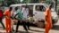 A wounded man is being carried into the General Hospital in Bangui on Sept. 26, 2015, after unknown assailants opened fire in the PK5 district, a neighborhood with a majority of Muslim residents.
