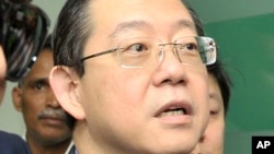 FILE - In this June 29, 2016, file photo, Lim Guan Eng, chief minister of northern Penang state, is arrested by the Malaysian Anti-Corruption Commission (MACC) at his office in Penang island, Malaysia.