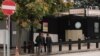 FILE - People are seen in front of the visa application office entrance of the U.S. Embassy in Ankara, Turkey, Oct. 9, 2017. The U.S. suspended all non-immigrant visa services in Turkey Oct 8. and has since resumed only limited services.