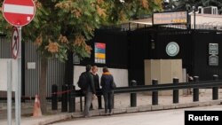 People wait in front of the visa application office entrance of the U.S. Embassy in Ankara, Turkey, Oct. 9, 2017. 