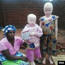 A woman poses with her children with albinism in northern Malawi. (L. Masina/VOA)