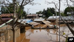 Warga setempat menggunakan perahu untuk melintasi jalan-jalan di antara rumah-rumah warga yang terendam banjir di Naypyitaw, Myanmar Minggu, 15 September 2024. 