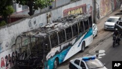 The shell of a bus is parked on the side of a road, allegedly set on fire by drug traffickers, in Rio de Janeiro, Brazil, May 2, 2017. Several public buses and cargo trucks were torched.