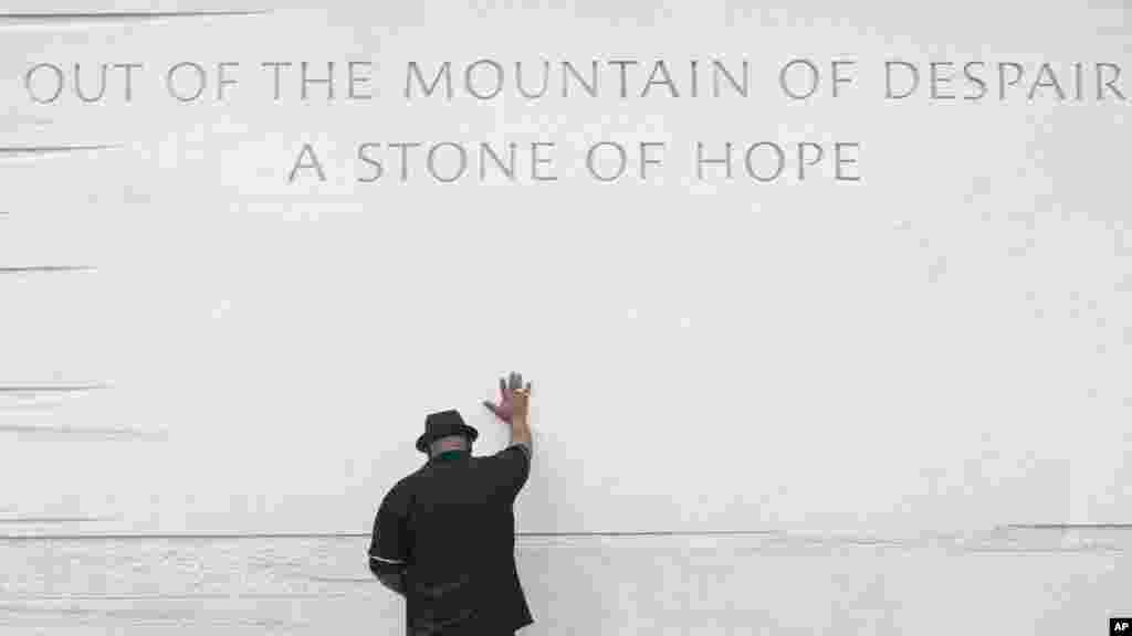 A marcher holds an U.S. flag bearing the image of President Barack Obama during the 50th anniversary of the 1963 March on Washington for Jobs and Freedom at the Lincoln Memorial in Washington Aug. 24, 2013. 