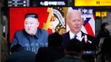 Commuters watch a TV showing a file image of North Korean leader Kim Jong Un and U.S. President Joe Biden during a news program at the Suseo Railway Station in Seoul, South Korea, Friday. March 26, 2021. 