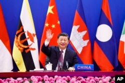 FILE - In this photo released by Xinhua News Agency, Chinese President Xi Jinping waves as he chairs the ASEAN-China Special Summit to commemorate the 30th Anniversary of ASEAN-China Dialogue Relations via video link from Beijing, China on Monday, Nov. 22, 2021.