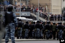 Protesters, monitored by scores of policemen, take part in a demonstration in downtown Moscow, Russia, June 12, 2017.